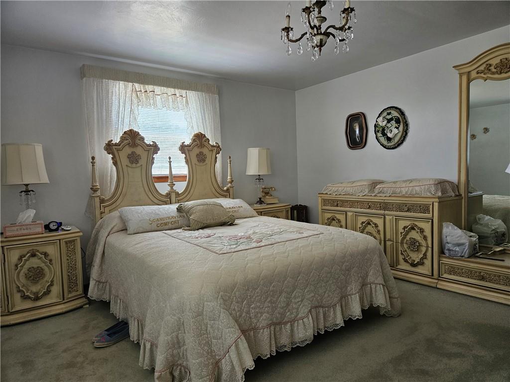 412 Cole Road Sarver, PA 16055 - Photo 23 of 48 a spacious bedroom with a bed and a chandelier