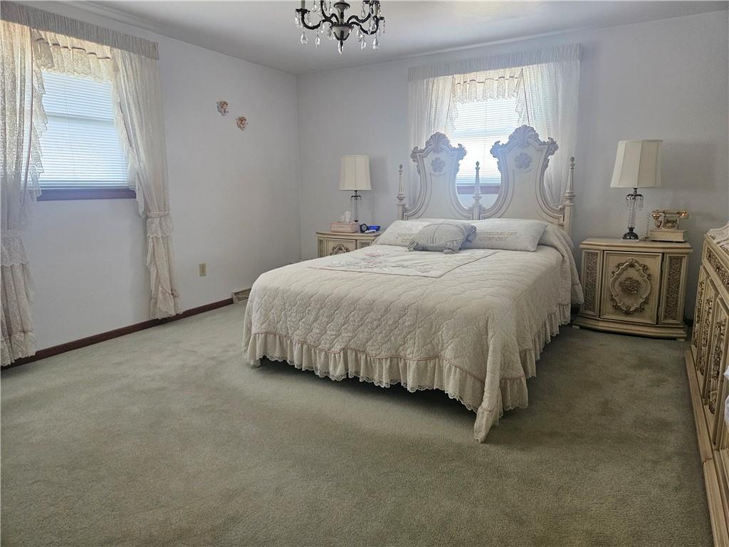 412 Cole Road Sarver, PA 16055 - Photo 47 of 48 a bed room with a bed and a chandelier