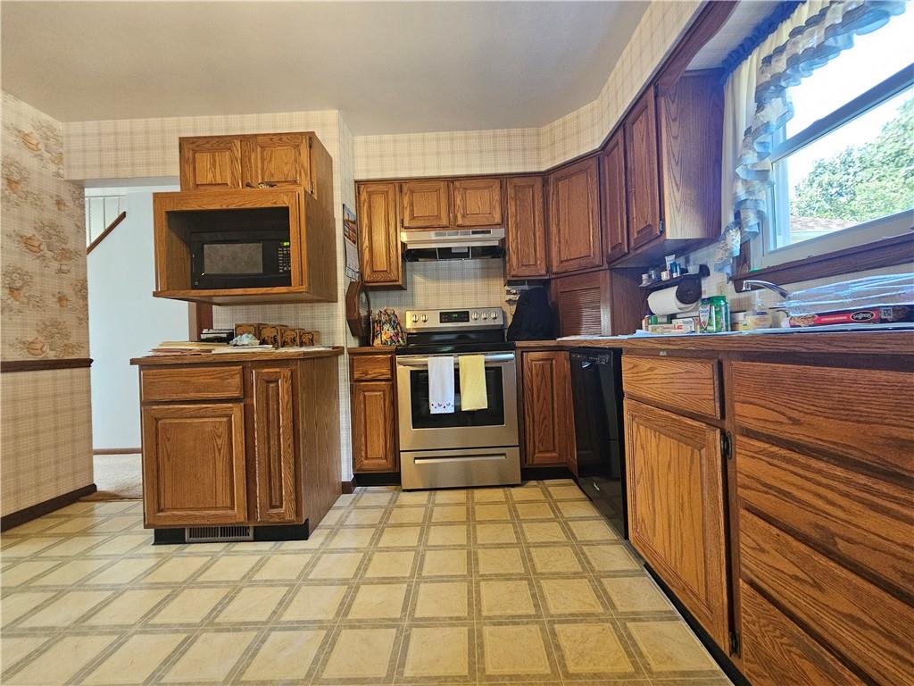412 Cole Road Sarver, PA 16055 - Photo 6 of 48 a kitchen with stainless steel appliances granite countertop a stove a sink and a microwave