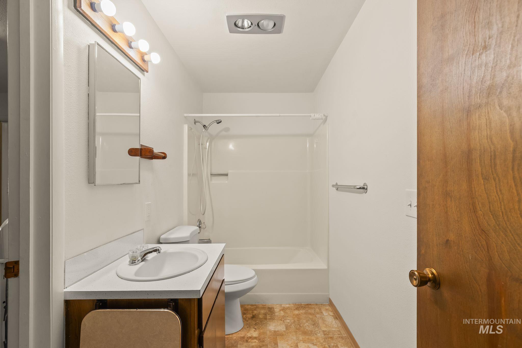 1721 3rd Street Lewiston, ID 83501 - Photo 13 of 45 Dedicated utility room featuring wood-finish cabinetry, a built-in sink, and a large window