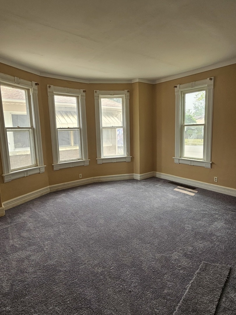 825 Black Road Joliet, IL 60435 - Photo 3 of 22 an empty room with windows
