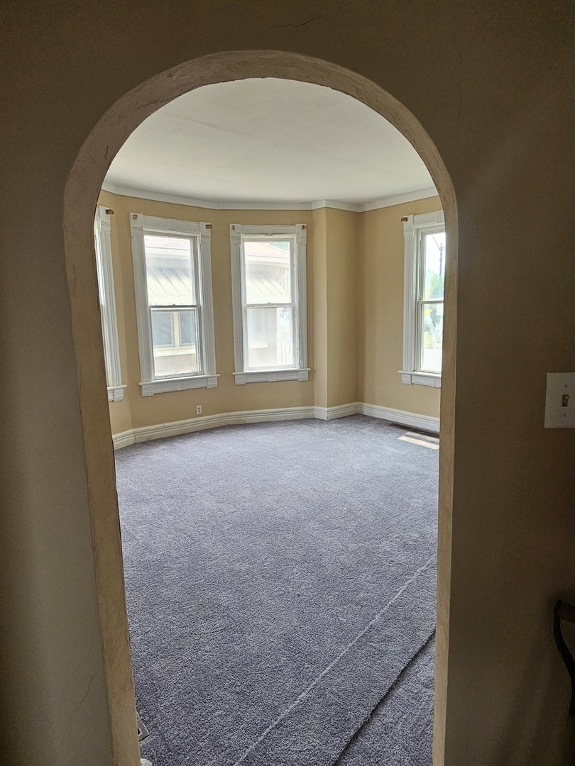 825 Black Road Joliet, IL 60435 - Photo 4 of 22 an empty room with a empty space and windows