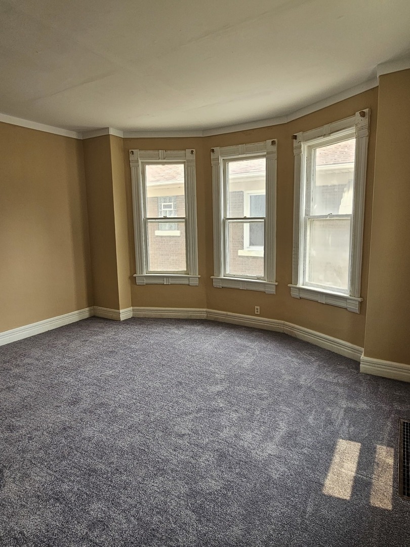 825 Black Road Joliet, IL 60435 - Photo 6 of 22 an empty room with windows