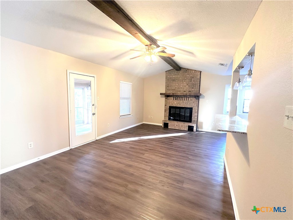 2204 Phyllis Drive Copperas Cove, TX 76522 - Photo 2 of 12 an empty room with wooden floor fireplace and windows