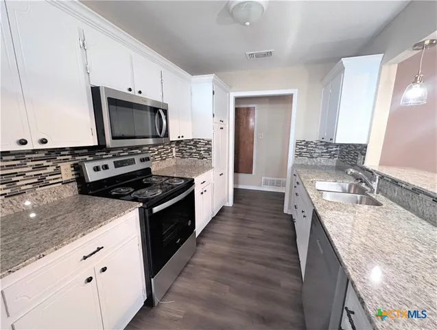 a large kitchen with a stove top oven