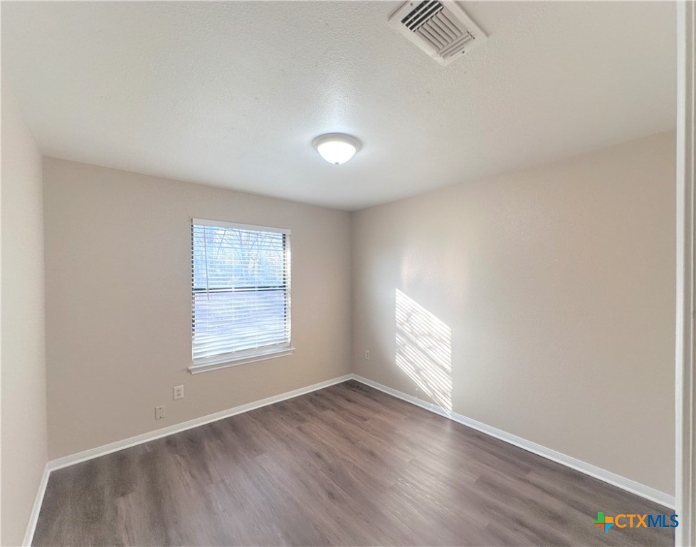 2204 Phyllis Drive Copperas Cove, TX 76522 - Photo 9 of 12 an empty room with wooden floor and windows