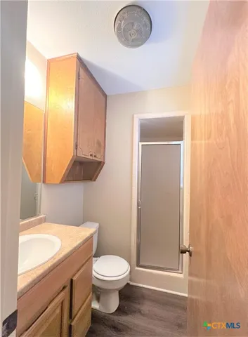 a bathroom with a toilet a sink a vanity and mirror