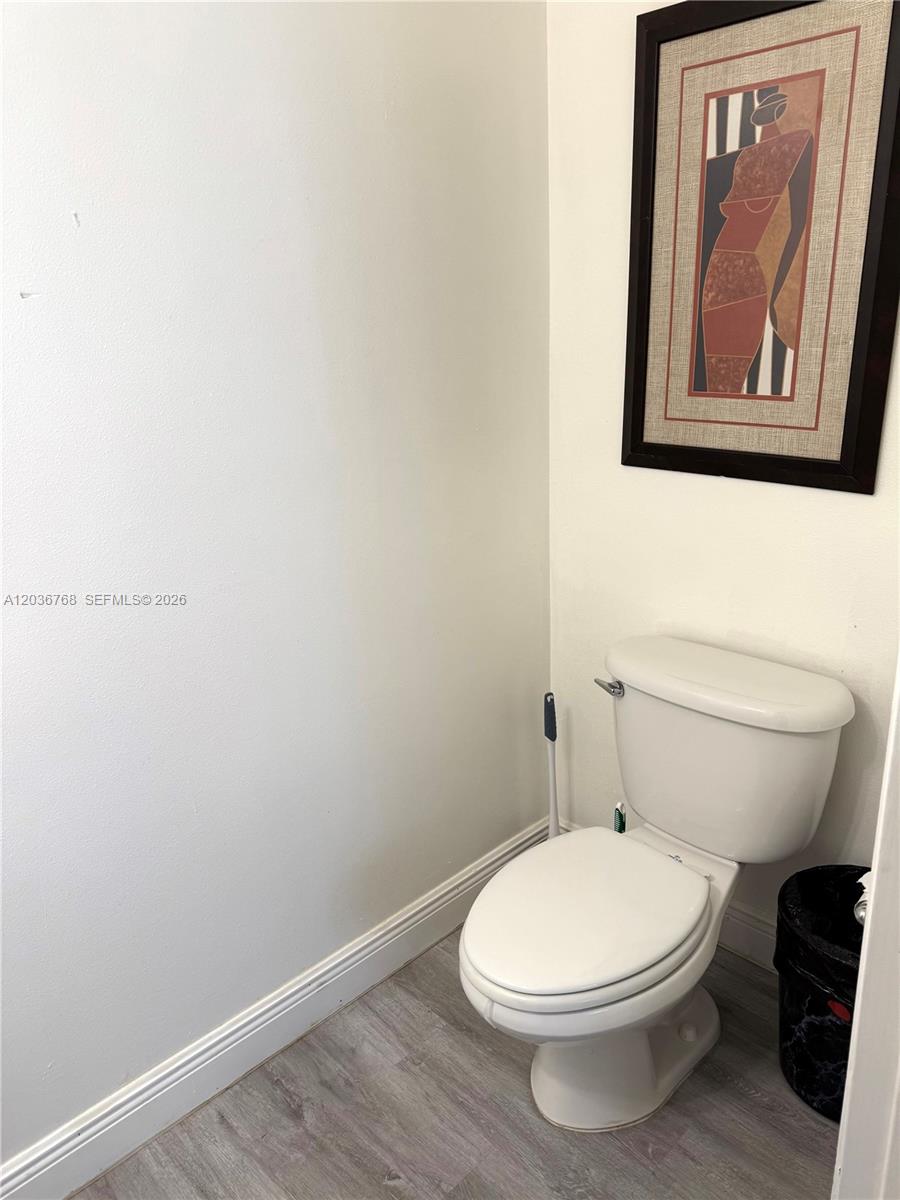 2432 Southwest 99th Way Miramar, FL 33025 - Photo 10 of 17 a white toilet sitting next to a white walls