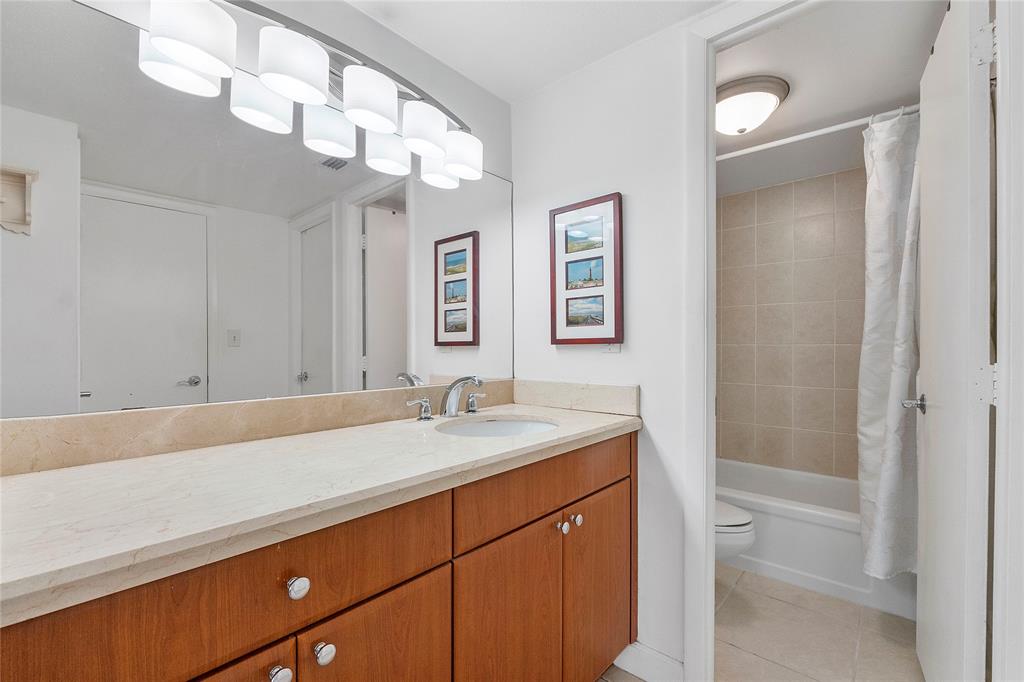 1900 South Ocean Boulevard, Unit 4H Pompano Beach, FL 33062 - Photo 14 of 35 a bathroom with a sink a vanity and a mirror