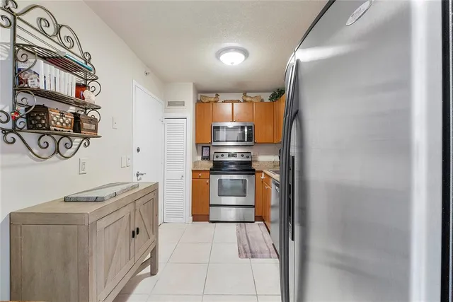 a kitchen with stainless steel appliances granite countertop a stove and a refrigerator