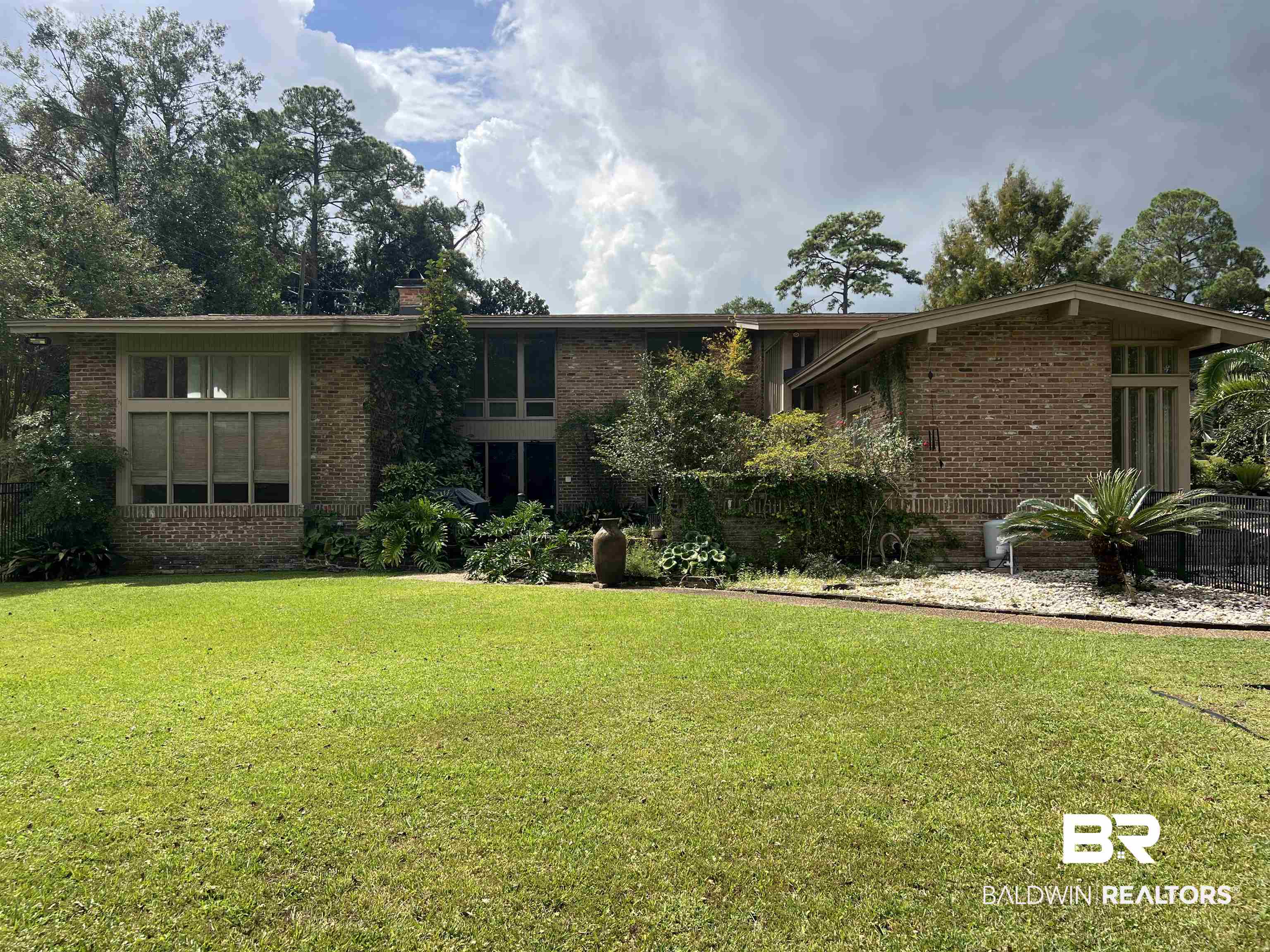 15 Spring Bank Road Mobile, AL 36608 - Photo 2 of 58 View of front of property featuring brick siding, a front yard, and a chimney