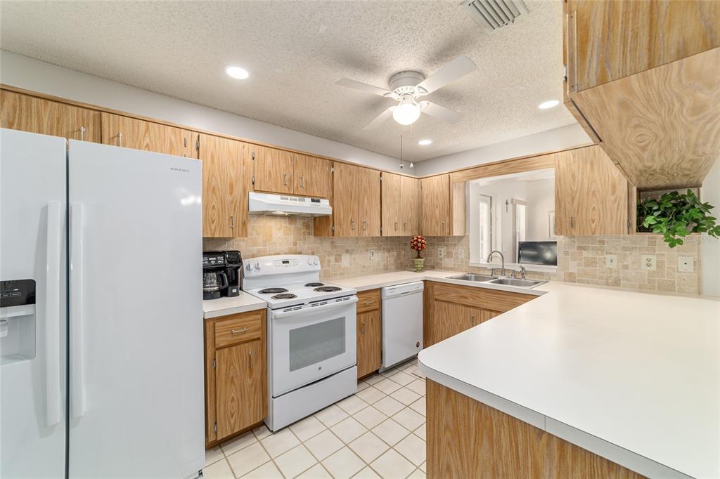 8530 Southwest 92 Street, Unit D Ocala, FL 34481 - Photo 15 of 42 a kitchen with a stove a sink and a refrigerator