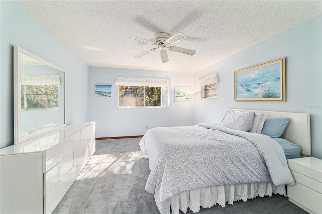 8530 Southwest 92 Street, Unit D Ocala, FL 34481 - Photo 18 of 42 a bedroom with a large bed and a chandelier