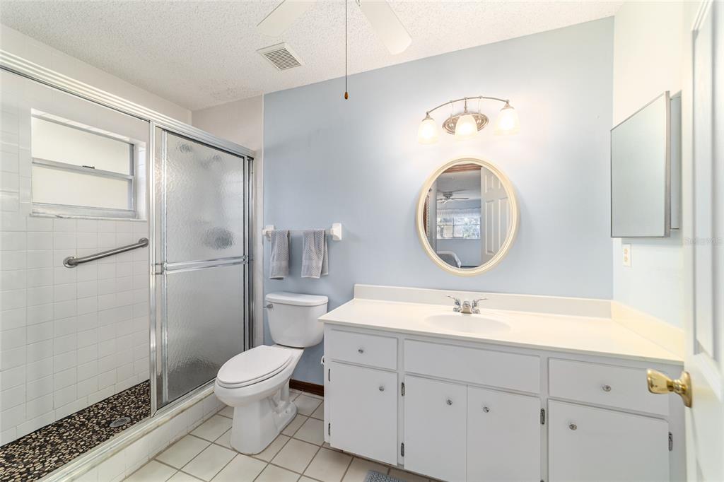 8530 Southwest 92 Street, Unit D Ocala, FL 34481 - Photo 20 of 42 a bathroom with a toilet sink and a mirror