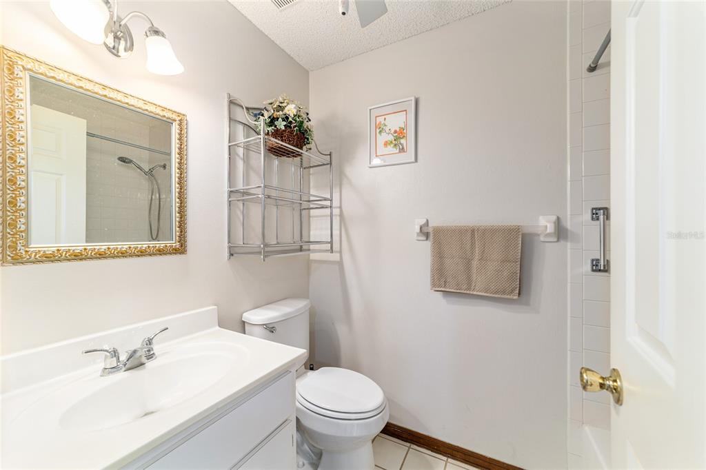 8530 Southwest 92 Street, Unit D Ocala, FL 34481 - Photo 23 of 42 a bathroom with a sink toilet and mirror