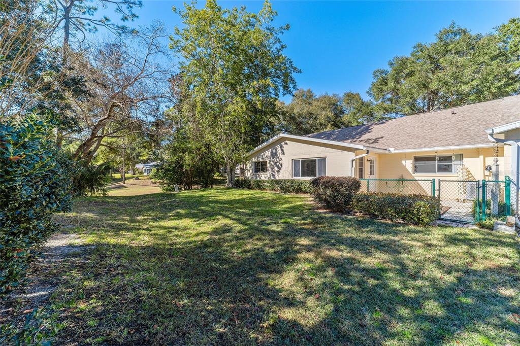 8530 Southwest 92 Street, Unit D Ocala, FL 34481 - Photo 32 of 42 a view of a house with a yard