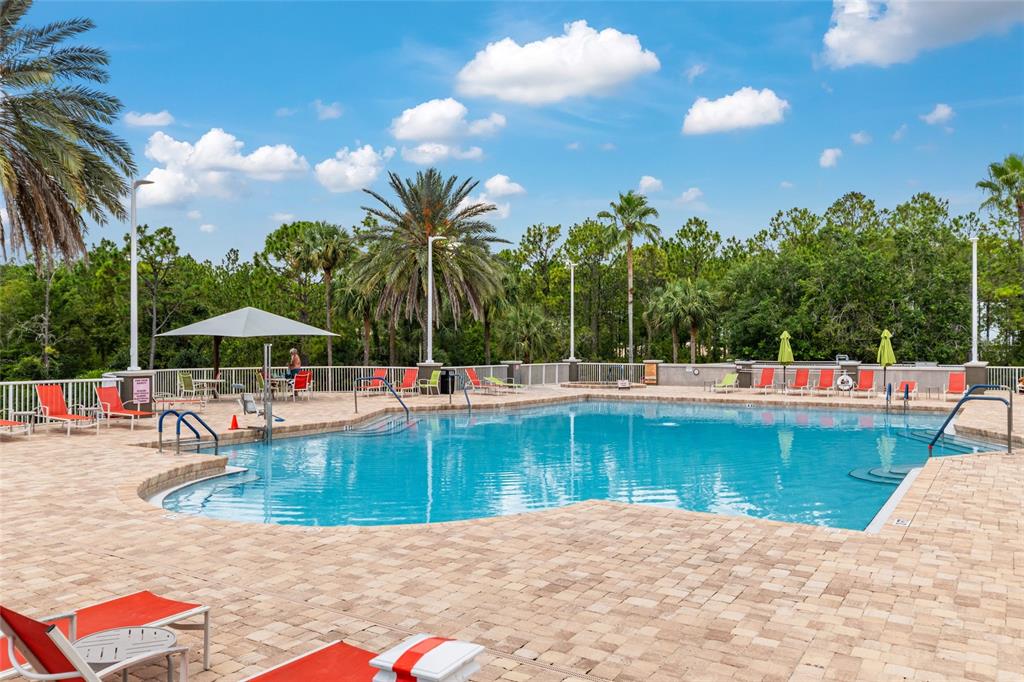 8530 Southwest 92 Street, Unit D Ocala, FL 34481 - Photo 33 of 42 a view of a swimming pool with a lounge chairs