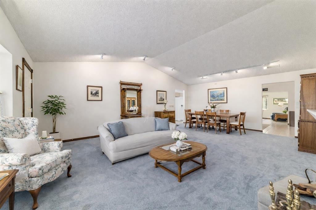 8530 Southwest 92 Street, Unit D Ocala, FL 34481 - Photo 6 of 42 a living room with furniture and wooden table