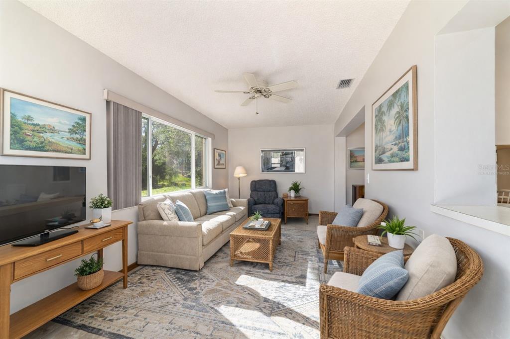 8530 Southwest 92 Street, Unit D Ocala, FL 34481 - Photo 10 of 42 a living room with furniture and a flat screen tv