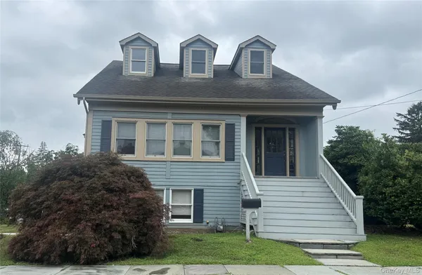 a front view of house with yard and green space