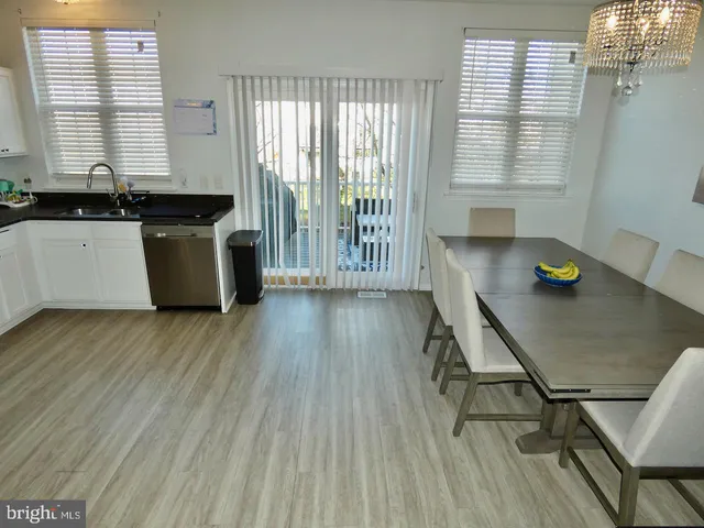 a kitchen with a wooden floor and a table