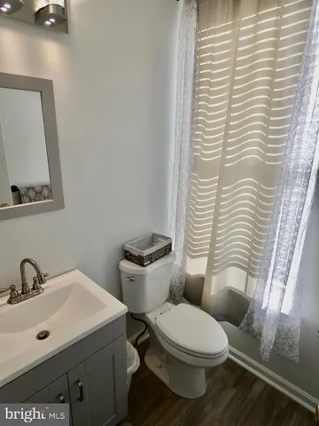 a white toilet sitting next to a bathroom sink