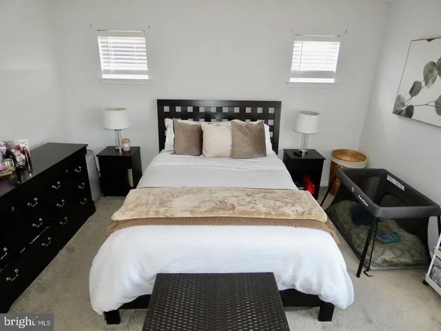 a bedroom with a bed and lamps