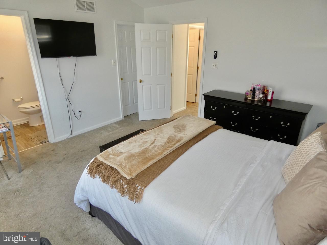 15 Wicklow Road Bear, DE 19701 - Photo 27 of 53 a bedroom with a bed a flat screen tv and a large window