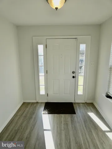 an entryway with wooden floor