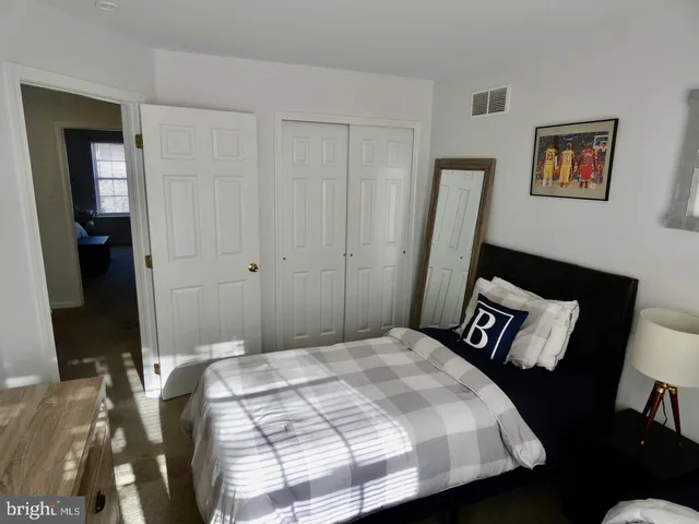 a bedroom with a bed and a dresser