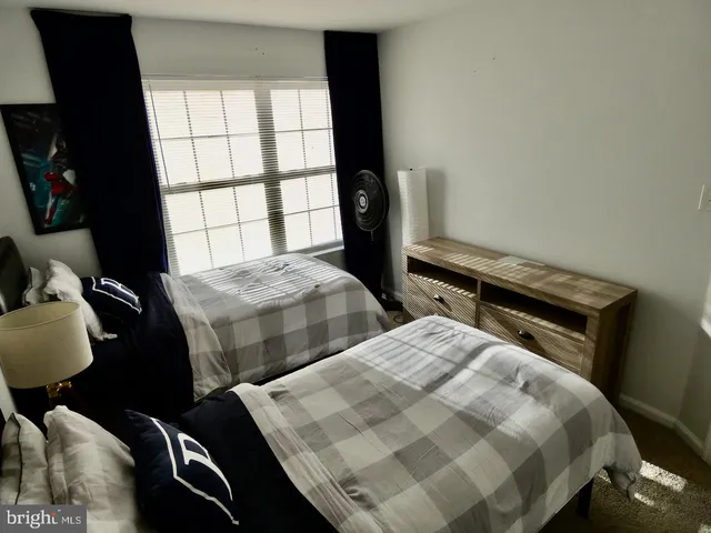 a bedroom with two beds and a window