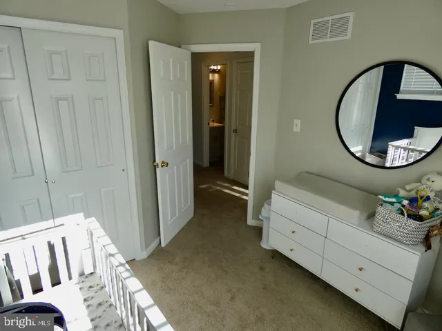 a bedroom with bed and a mirror