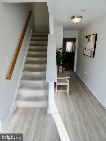 a view of entryway and hall with wooden floor