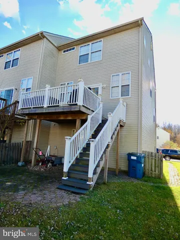 a view of a house with backyard and deck