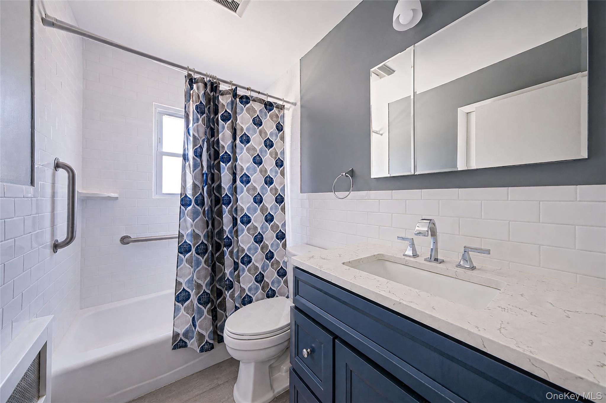 59 Maybrook Road North Babylon, NY 11703 - Photo 12 of 43 a bathroom with a sink a toilet and shower