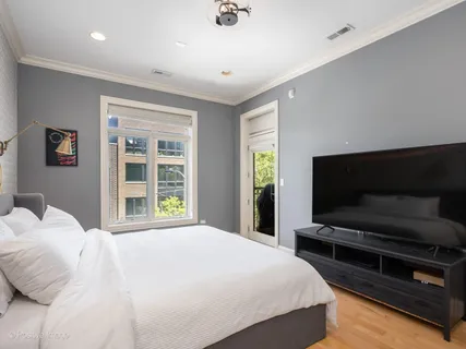 a bedroom with a bed and a television
