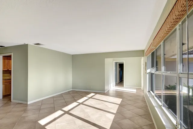 a view of a bedroom with wooden floor and windows