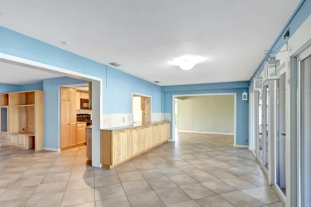 a view of a big room with windows and cabinet