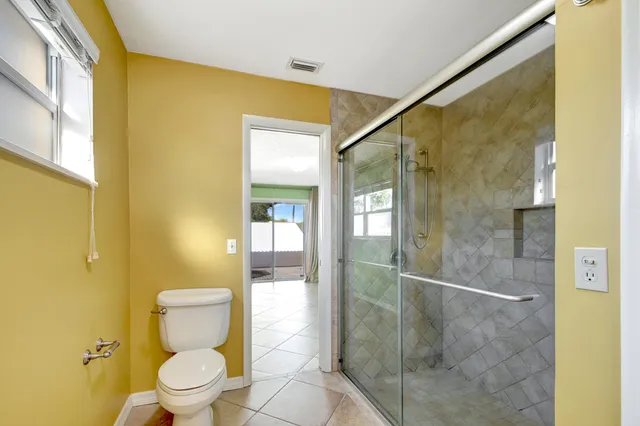 a bathroom with a toilet and a shower