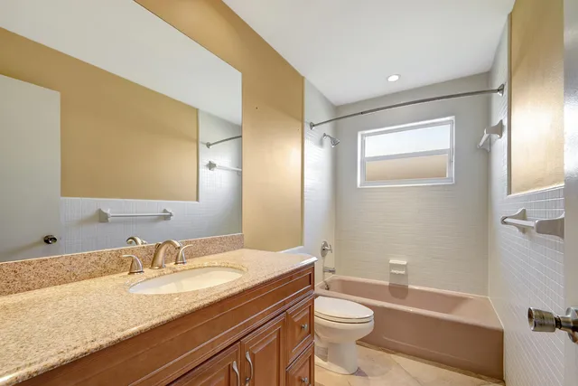 an empty room with a window and a ceiling fan