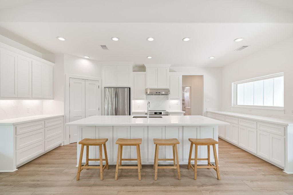 4294 Brazos River Road, Unit CR400 Freeport, TX 77541 - Photo 24 of 50 a kitchen with kitchen island cabinets and wooden floor