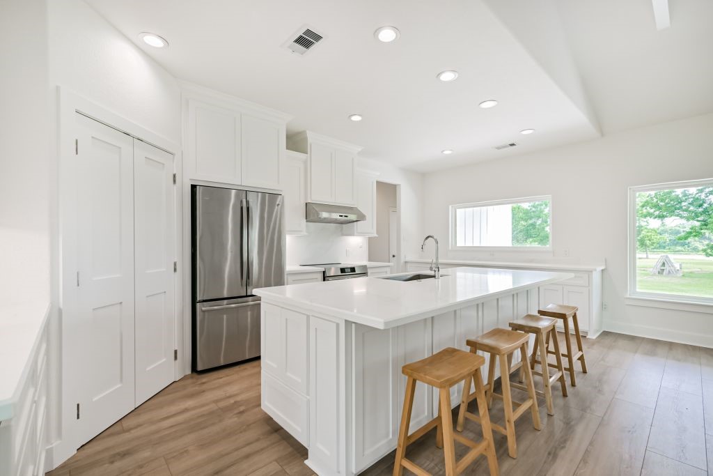 4294 Brazos River Road, Unit CR400 Freeport, TX 77541 - Photo 25 of 50 a kitchen with stainless steel appliances a refrigerator a sink a stove a table and chairs