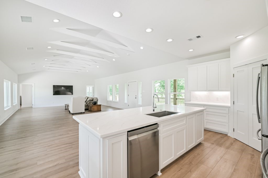 4294 Brazos River Road, Unit CR400 Freeport, TX 77541 - Photo 30 of 50 a kitchen with sink a refrigerator and white cabinets