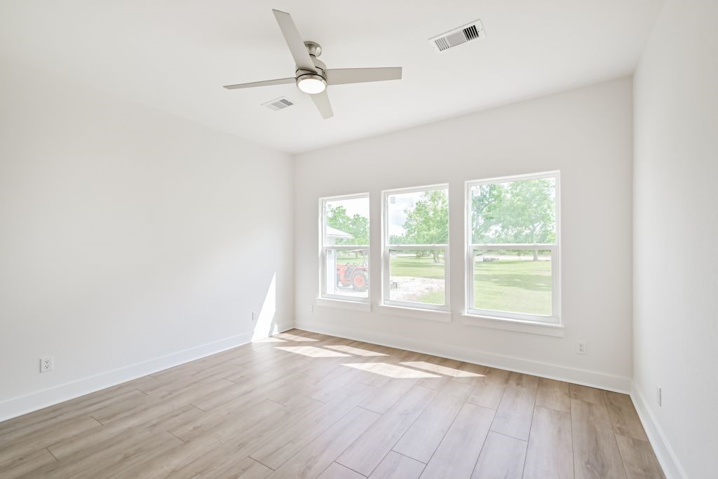 4294 Brazos River Road, Unit CR400 Freeport, TX 77541 - Photo 33 of 50 an empty room with wooden floor fan and windows