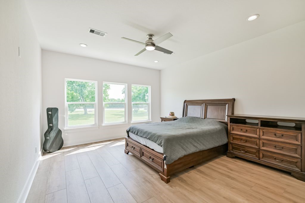 4294 Brazos River Road, Unit CR400 Freeport, TX 77541 - Photo 38 of 50 a bedroom with a large bed and a large window