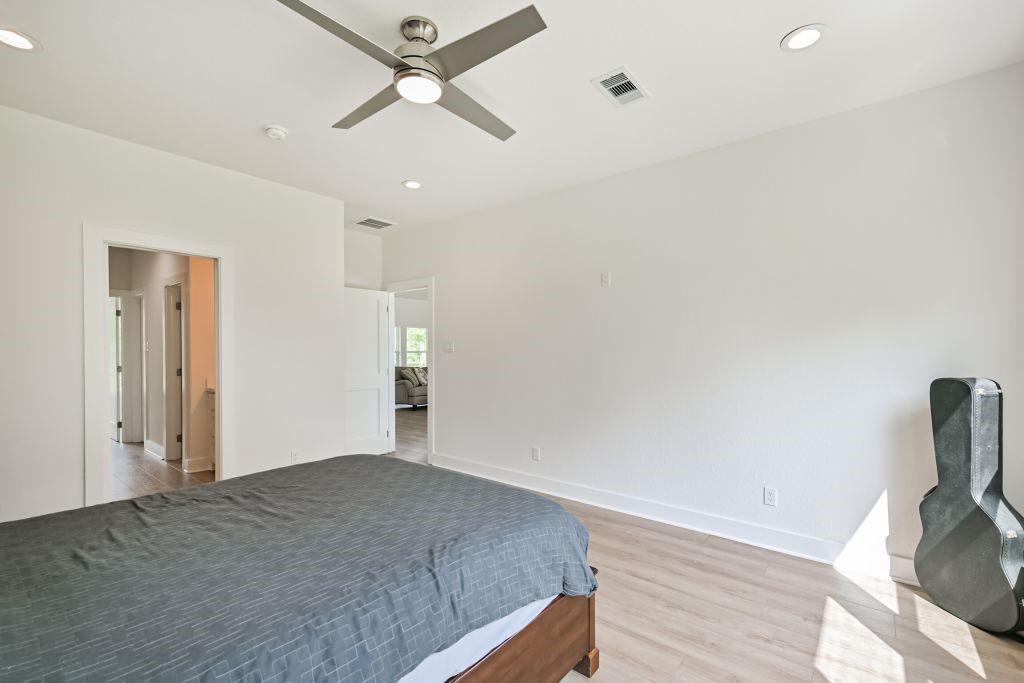 4294 Brazos River Road, Unit CR400 Freeport, TX 77541 - Photo 39 of 50 a bedroom with a bed and a chandelier