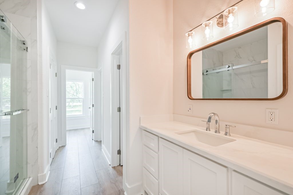 4294 Brazos River Road, Unit CR400 Freeport, TX 77541 - Photo 40 of 50 a en suite bathroom with a double vanity sink and a mirror