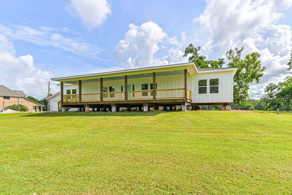 4294 Brazos River Road, Unit CR400 Freeport, TX 77541 - Photo 4 of 50 a front view of a house with a garden