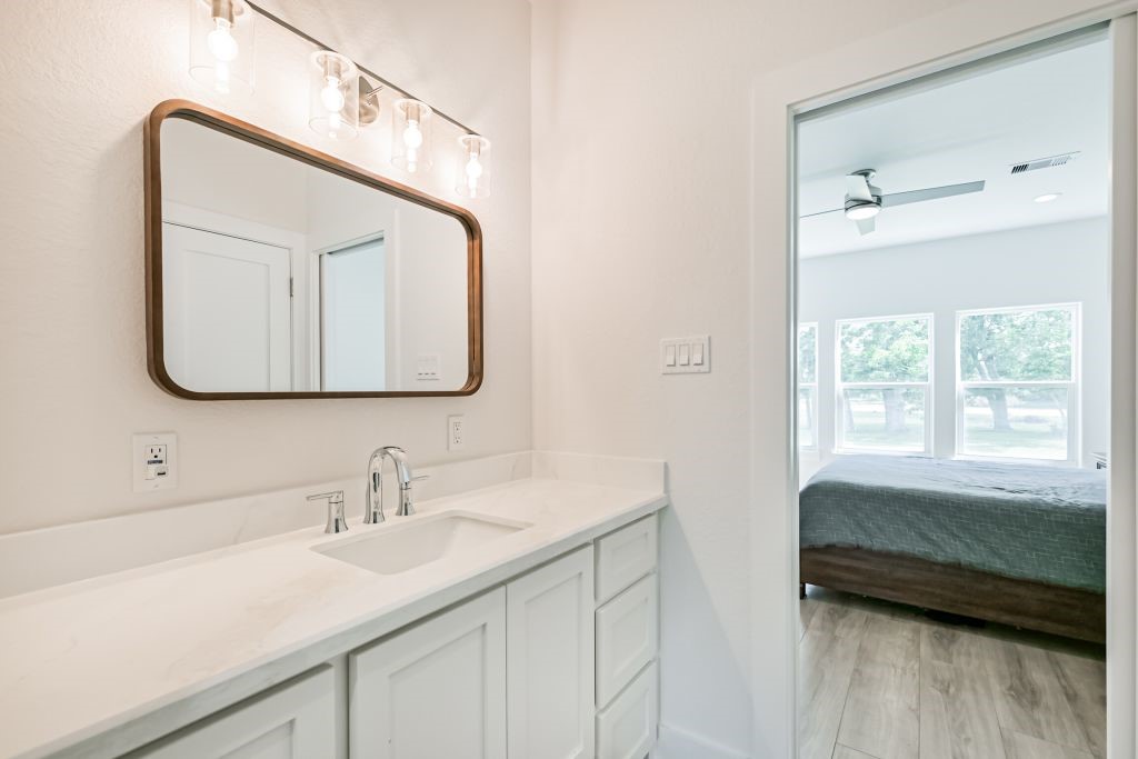 4294 Brazos River Road, Unit CR400 Freeport, TX 77541 - Photo 42 of 50 a en suite bathroom with a double vanity sink and a mirror