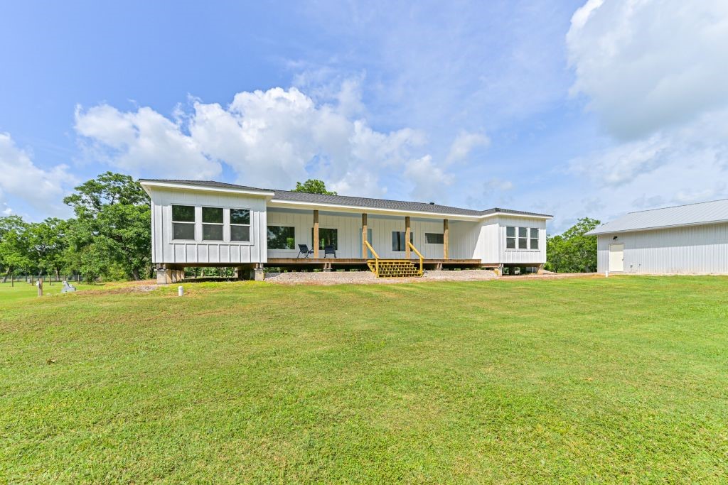 4294 Brazos River Road, Unit CR400 Freeport, TX 77541 - Photo 8 of 50 a front view of a house with a garden and lake view